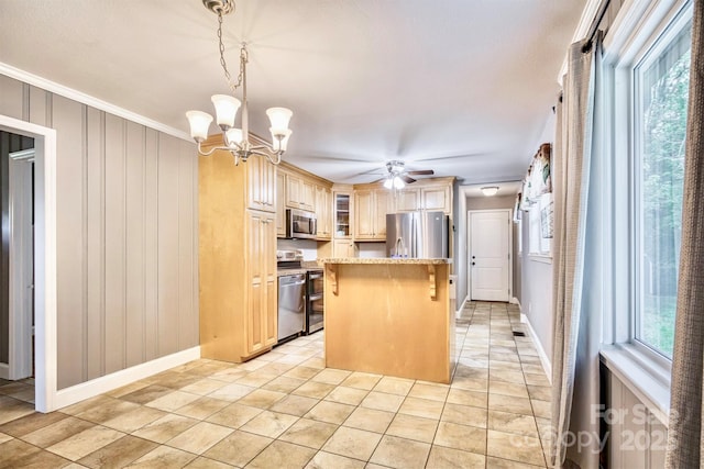 4897 Calico Rd, Lenoir, NC 28645 - kitchen with stainless steel appliances, healthy amount of natural light, a breakfast bar, a kitchen island, and crown molding
