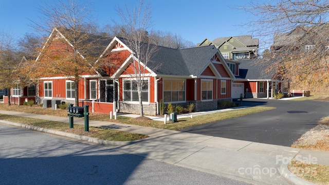 20 Brookstone Pl, Candler, NC 28715 - craftsman-style home with stone siding, driveway, roof with shingles, and a garage