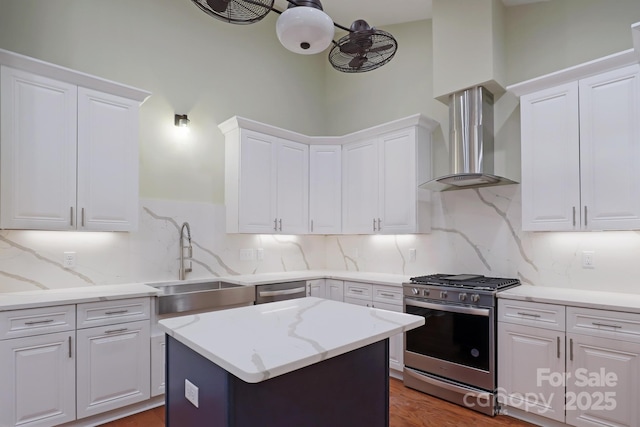 20 Brookstone Pl, Candler, NC 28715 - kitchen with stainless steel appliances, extractor fan, white cabinetry, decorative backsplash, and a center island