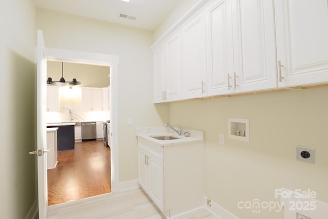 20 Brookstone Pl, Candler, NC 28715 - washroom featuring cabinet space, hookup for an electric dryer, hookup for a washing machine, and light wood-style floors