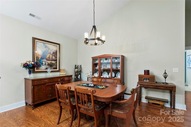 20 Brookstone Pl, Candler, NC 28715 - dining space featuring a chandelier, light wood-style floors, and vaulted ceiling