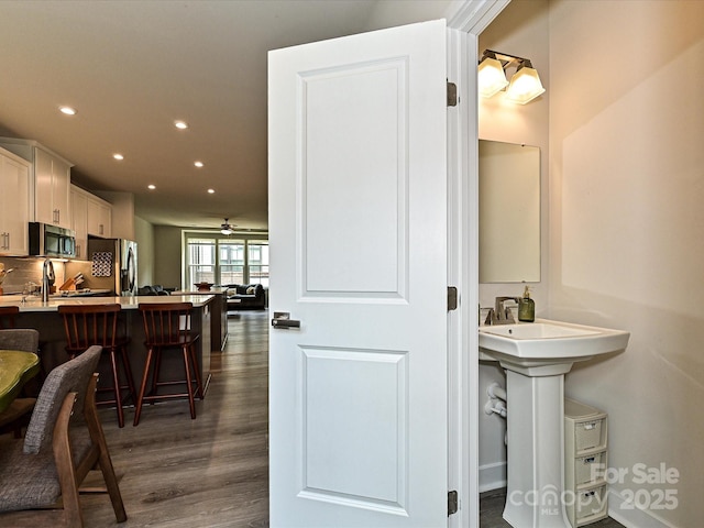 interior space with recessed lighting, a ceiling fan, and dark wood-style flooring