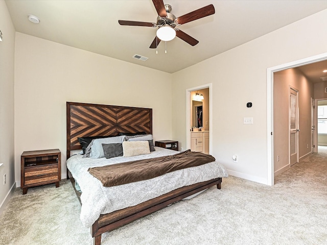 carpeted bedroom featuring baseboards, visible vents, a ceiling fan, and ensuite bathroom