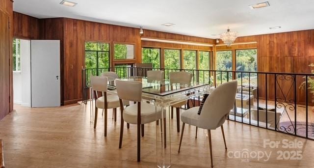 916 E Park Dr, Lincolnton, NC 28092 - dining room featuring wood walls, a chandelier, and light wood-type flooring