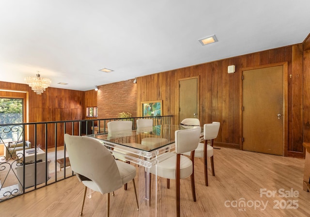 916 E Park Dr, Lincolnton, NC 28092 - dining area featuring a chandelier, wooden walls, and light wood-style flooring