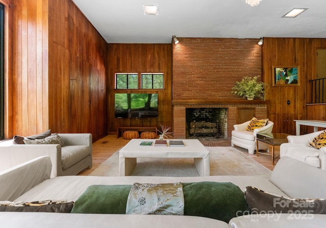 916 E Park Dr, Lincolnton, NC 28092 - living room featuring wood walls, wood finished floors, and a fireplace
