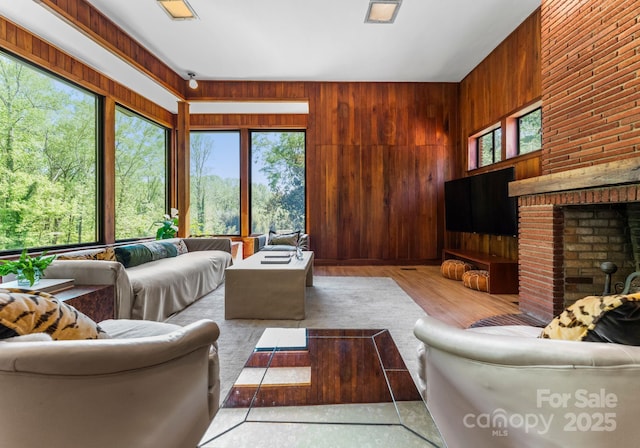916 E Park Dr, Lincolnton, NC 28092 - living area with healthy amount of natural light, wood walls, and a brick fireplace