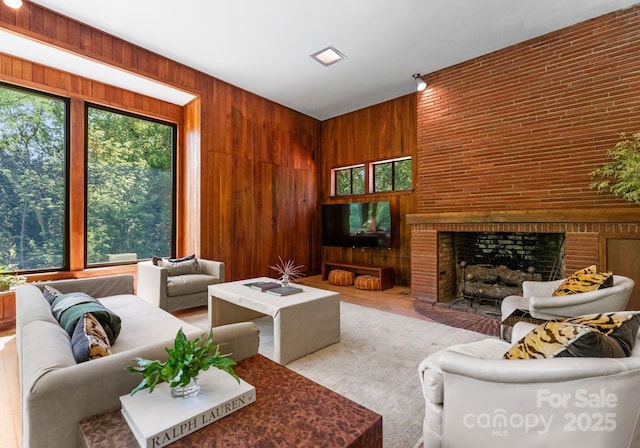916 E Park Dr, Lincolnton, NC 28092 - living room featuring wooden walls, a brick fireplace, and wood finished floors