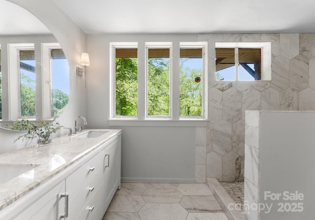 916 E Park Dr, Lincolnton, NC 28092 - full bath featuring plenty of natural light, marble look tiles, a walk in shower, and double vanity