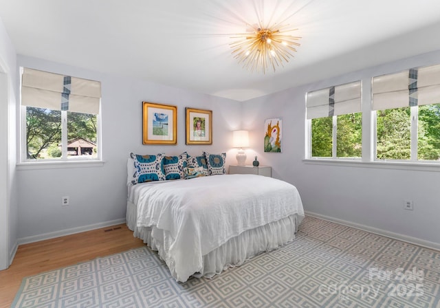 916 E Park Dr, Lincolnton, NC 28092 - bedroom featuring wood finished floors, baseboards, and a chandelier