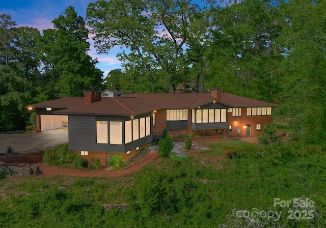 916 E Park Dr, Lincolnton, NC 28092 - back of property at dusk featuring a chimney, an outdoor structure, and a garage