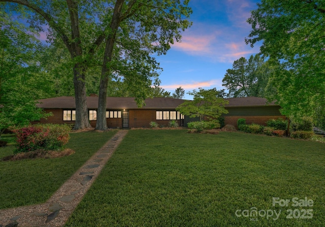 916 E Park Dr, Lincolnton, NC 28092 - view of front of house featuring brick siding and a yard