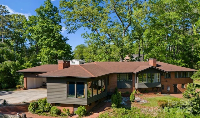 916 E Park Dr, Lincolnton, NC 28092 - rear view of property featuring a chimney, concrete driveway, a carport, a shingled roof, and brick siding
