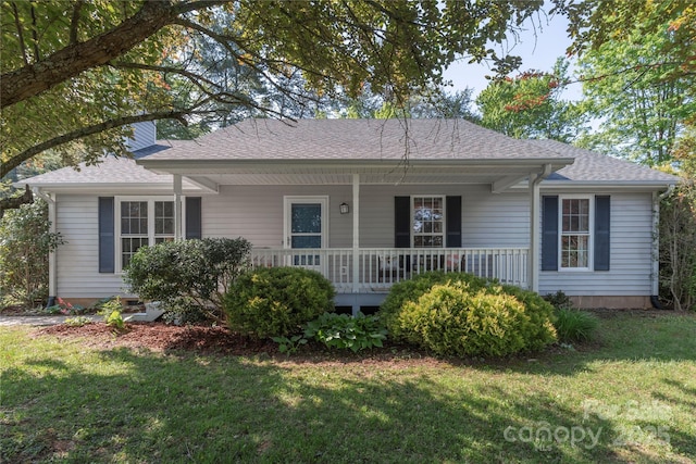 view of front of house with a shingled roof, a porch, and a front lawn