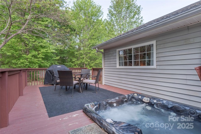 wooden terrace featuring outdoor dining area, area for grilling, and hot tub deck surround