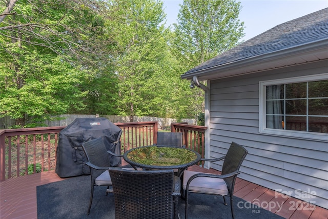 deck featuring fence, outdoor dining space, and area for grilling