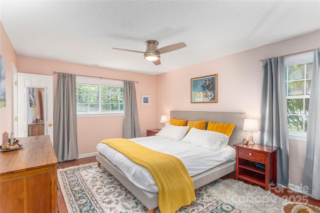 bedroom featuring baseboards, a ceiling fan, and wood finished floors