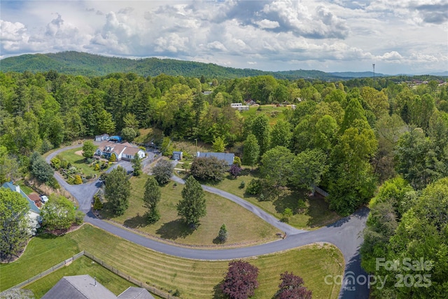 aerial view featuring a wooded view