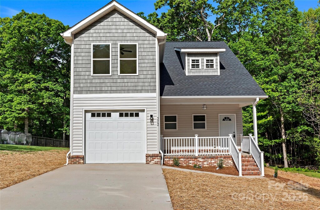 5064 Joyce Ave, Winston Salem, NC 27106 - craftsman house with fence, a shingled roof, a garage, concrete driveway, and covered porch