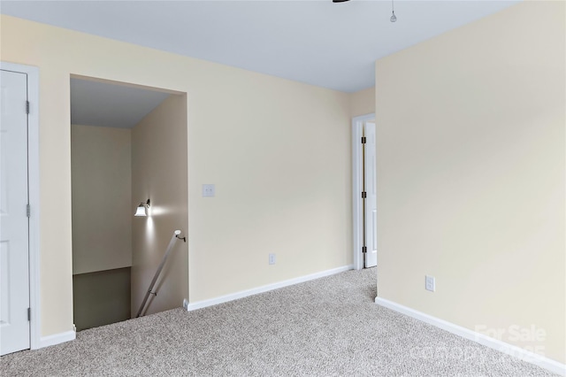 carpeted spare room with baseboards