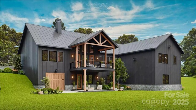 rear view of property featuring a chimney, a balcony, metal roof, and a yard