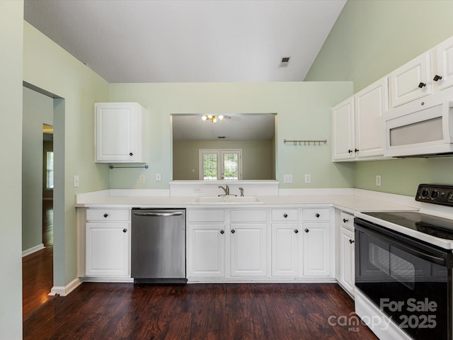 kitchen featuring electric stove, stainless steel dishwasher, white microwave, a sink, and dark wood-type flooring