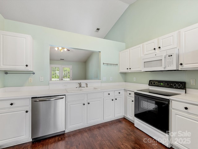 kitchen with range with electric cooktop, stainless steel dishwasher, a sink, vaulted ceiling, and white microwave
