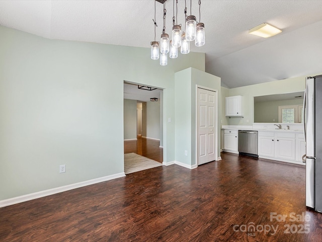 unfurnished dining area featuring baseboards, a textured ceiling, dark wood-style flooring, and lofted ceiling