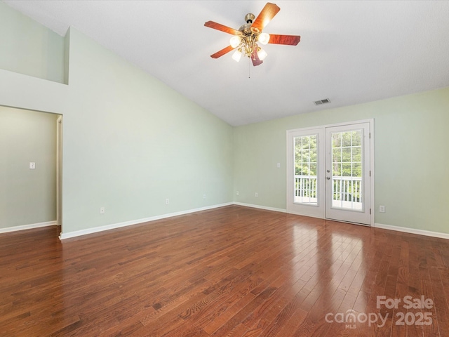 spare room with ceiling fan, high vaulted ceiling, visible vents, baseboards, and wood finished floors