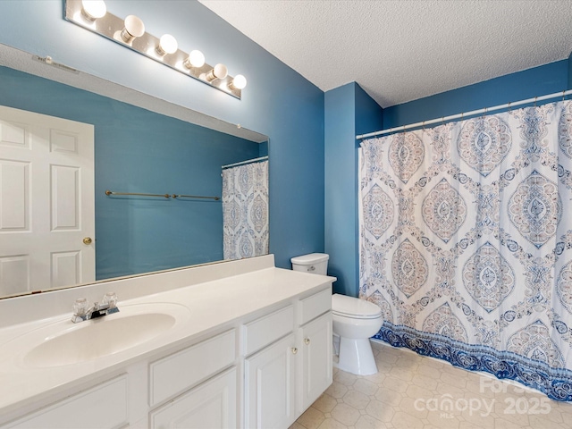 bathroom featuring curtained shower, toilet, a textured ceiling, and vanity