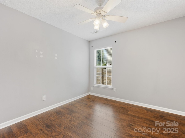 unfurnished room featuring wood finished floors, baseboards, visible vents, a ceiling fan, and a textured ceiling