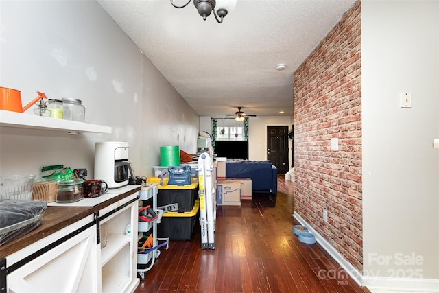 1766 Forest Side Ln, Charlotte, NC 28213 - hallway with a textured ceiling, brick wall, and dark wood-type flooring