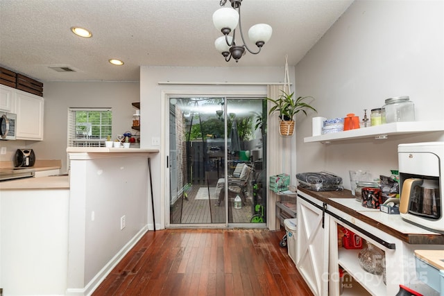1766 Forest Side Ln, Charlotte, NC 28213 - doorway featuring an inviting chandelier, a textured ceiling, dark wood finished floors, recessed lighting, and visible vents