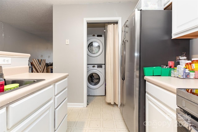 1766 Forest Side Ln, Charlotte, NC 28213 - clothes washing area featuring stacked washing maching and dryer, light floors, laundry area, and a sink