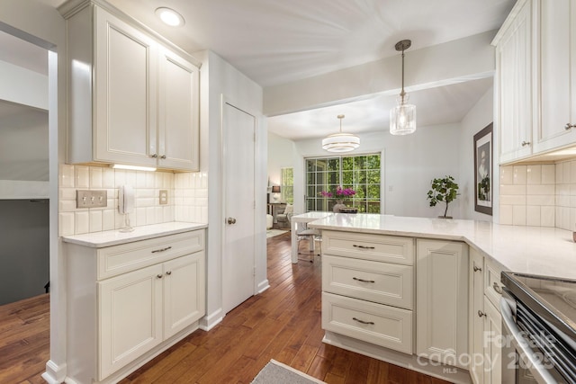 9012 Saint Thomas Ln, Charlotte, NC 28277 - kitchen with hanging light fixtures, decorative backsplash, a peninsula, and dark wood-style floors