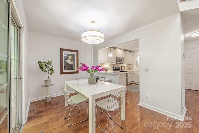 9012 Saint Thomas Ln, Charlotte, NC 28277 - dining space with light wood-type flooring and baseboards