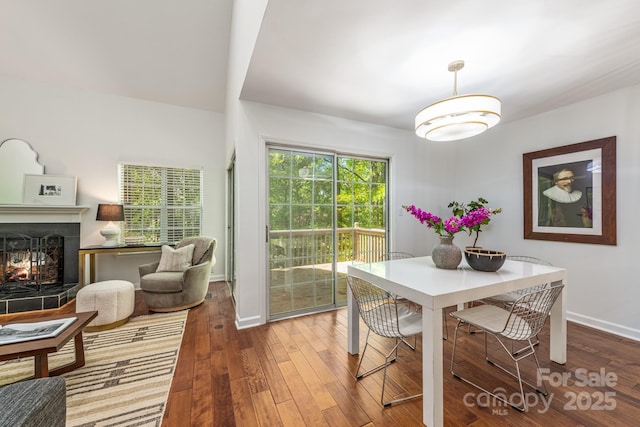9012 Saint Thomas Ln, Charlotte, NC 28277 - dining room with hardwood / wood-style flooring, baseboards, and a multi sided fireplace