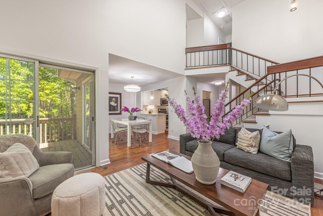 9012 Saint Thomas Ln, Charlotte, NC 28277 - living room with baseboards, a high ceiling, and wood finished floors