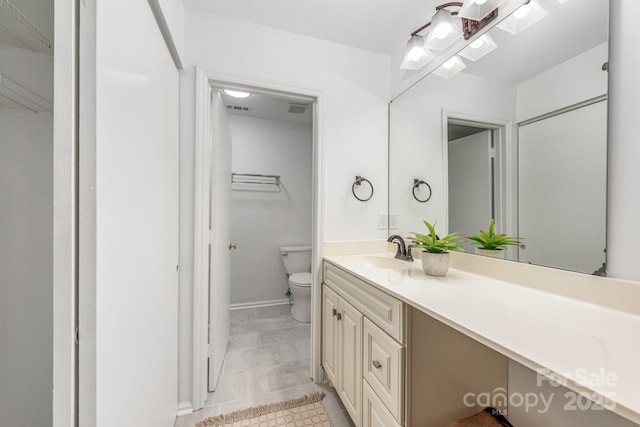 9012 Saint Thomas Ln, Charlotte, NC 28277 - bathroom featuring visible vents, toilet, vanity, and baseboards