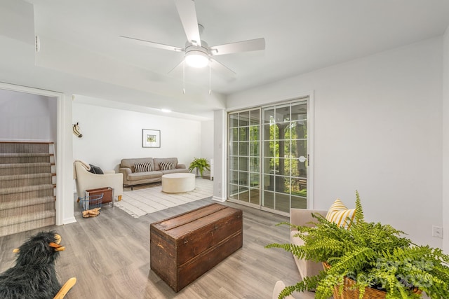 9012 Saint Thomas Ln, Charlotte, NC 28277 - living area with light wood-style flooring, a ceiling fan, and stairway
