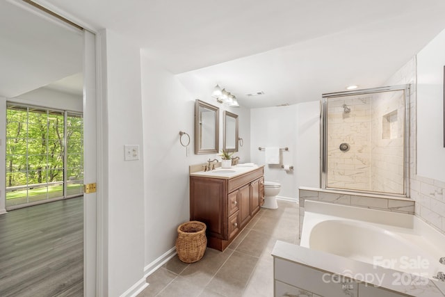 9012 Saint Thomas Ln, Charlotte, NC 28277 - bathroom with baseboards, toilet, vanity, a stall shower, and a garden tub