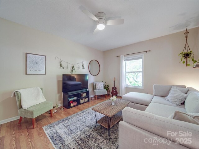 215 6th St, Belmont, NC 28012 - living area with a ceiling fan, wood finished floors, and baseboards