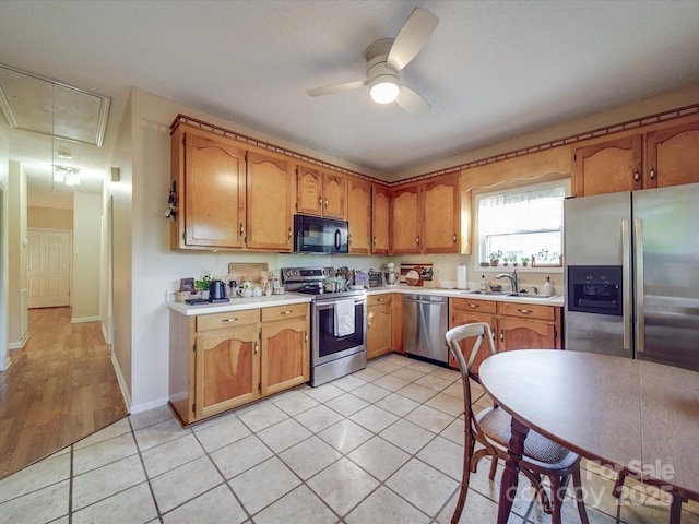 215 6th St, Belmont, NC 28012 - kitchen with stainless steel appliances, a sink, light countertops, and a ceiling fan