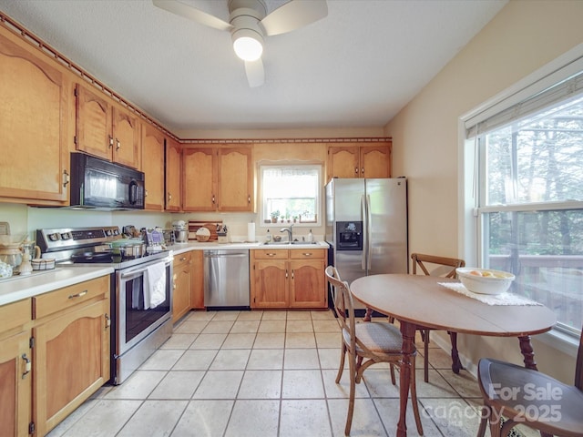 215 6th St, Belmont, NC 28012 - kitchen with stainless steel appliances, ceiling fan, a sink, and light countertops