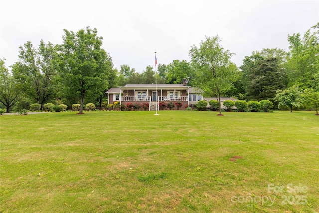ranch-style home with a chimney, a porch, and a front yard