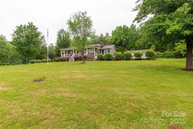 view of yard featuring covered porch
