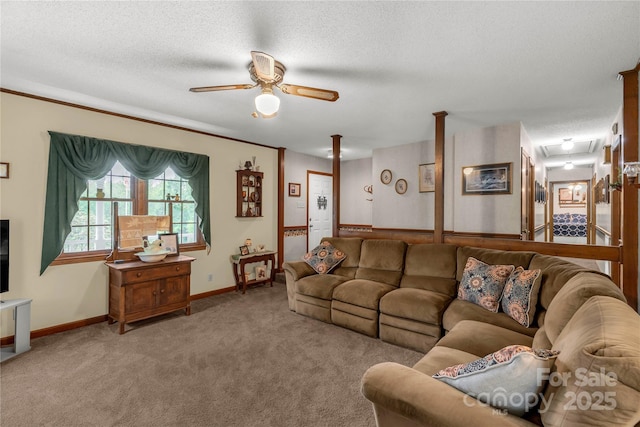 carpeted living room with a textured ceiling, ceiling fan, and baseboards