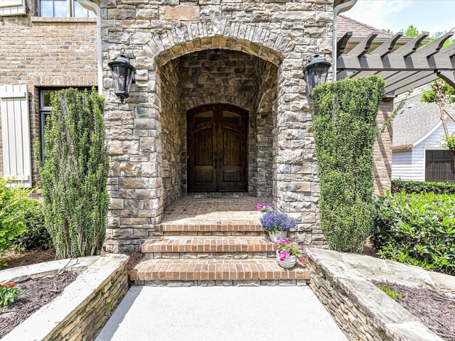 entrance to property featuring stone siding