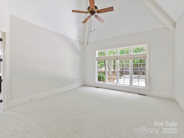 carpeted empty room with high vaulted ceiling, ceiling fan, baseboards, and visible vents