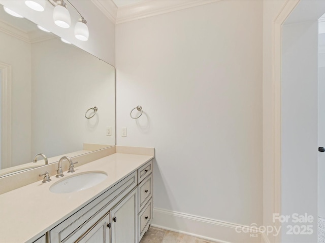 bathroom with baseboards, crown molding, and vanity